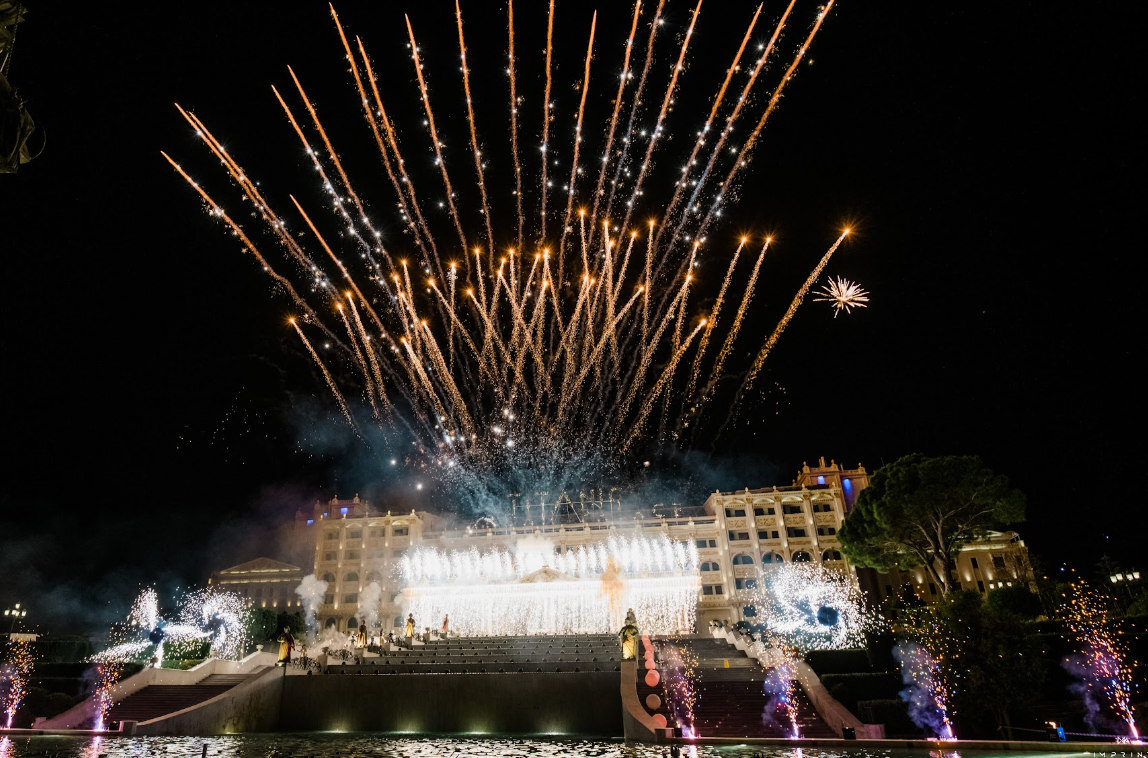 Fireworks above illuminated event venue
