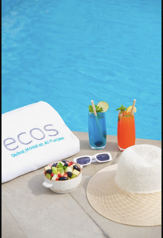 Pool with drinks, hat, fruit and sunglasses