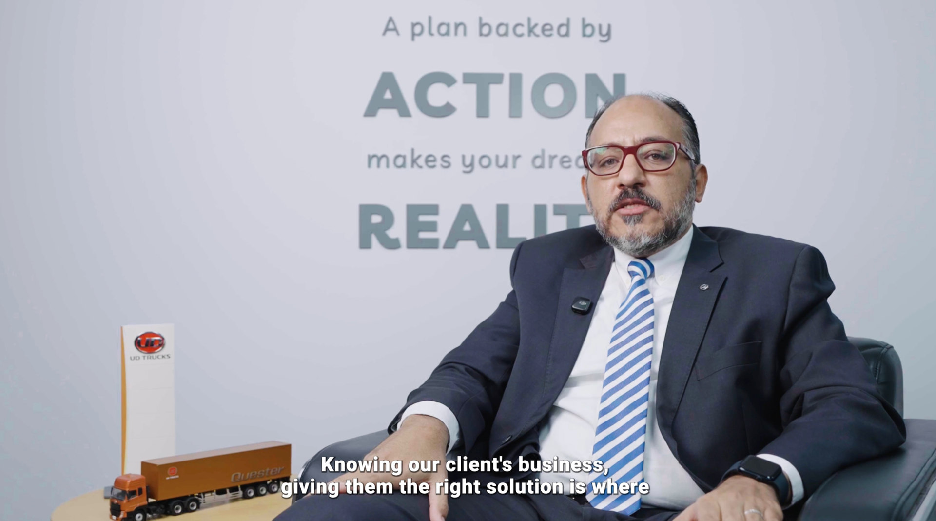 Executive in suit delivering on-camera interview